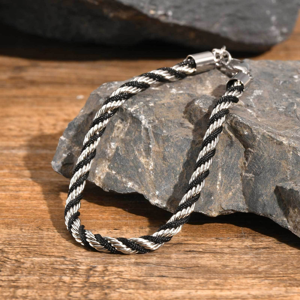 Cycolinks Stainless Steel Black Braided Rope Twist Bracelet - Silver Variant
  on a rock