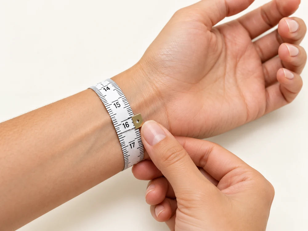 A soft measuring tape wrapped snugly around the wrist above the wrist bone.